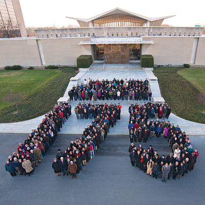 people standing together to create the shape of the number 175
