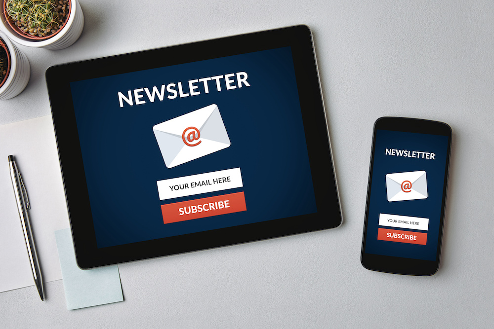 Tablet and cell phone showing an envelope and the word NEWSLETTER